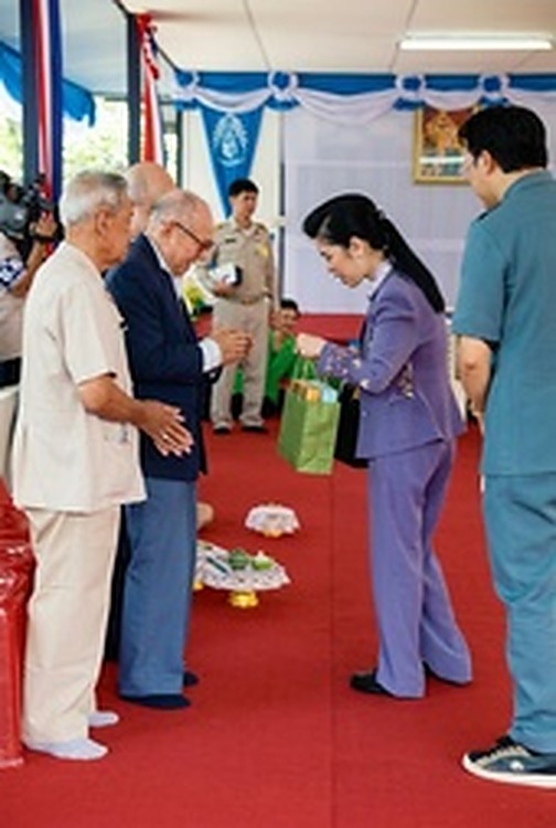 2005年9月15日：白发苍苍的和平村老战士们列队立于红地毯上，向朱拉蓬公主呈献当地特产与手工艺品。