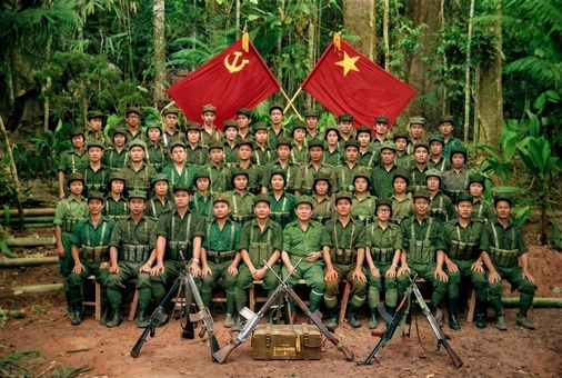 1970年代后期至1980年代马来亚民族解放军各支队指战员在边境丛林根据地高举马共党旗与军旗整装合影历史实照（第6帧）